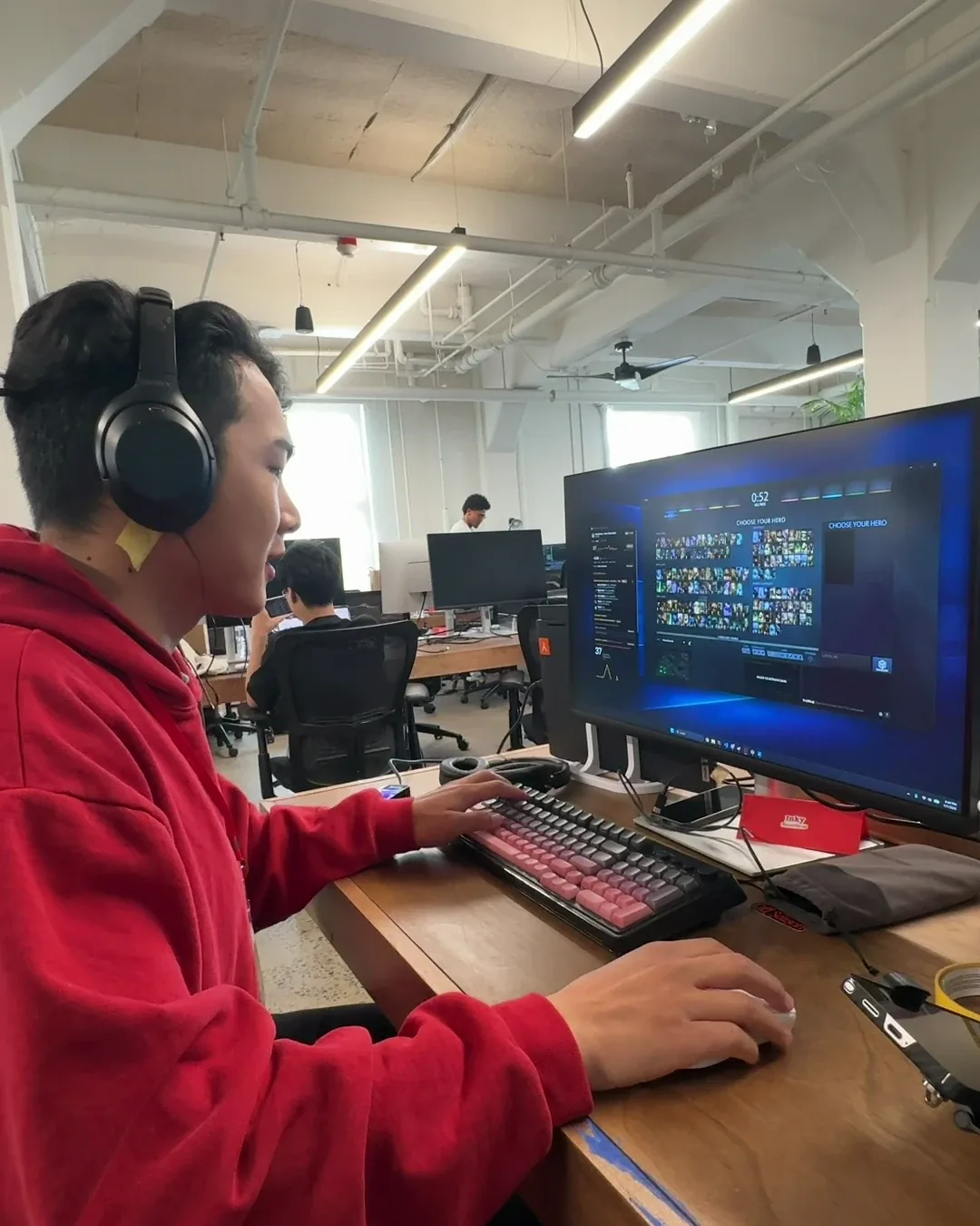 Pilot session: tester wearing over-ear headphones while working at a desk